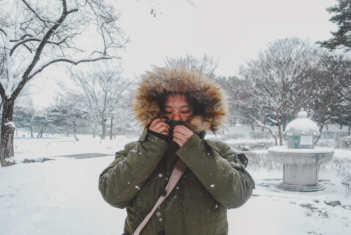 girl in winter coat with snowy back ground -what to wear in korea in the winter